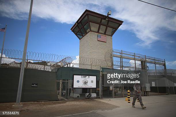 Military officer walks from the entrance to Camp VI at the U.S. Military prison for 'enemy combatants' on June 25, 2013 in Guantanamo Bay, Cuba....