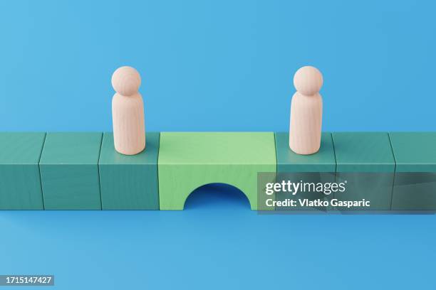 bridge between two wooden figurines - bridging the gap concepts -heart stock pictures, royalty-free photos & images