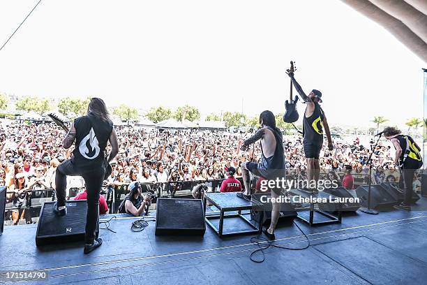 Guitarist Zach Huston, vocalist Chris Roetter, bassist Aaron Evans and guitarist Eli Ford of Like Moths to Flames perform at the Vans Warped Tour at...