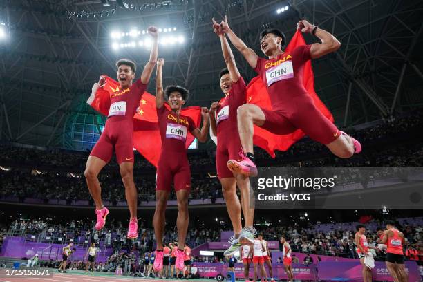 Chen Guanfeng, Xie Zhenye, Yan Haibin and Chen Jiapeng of Team China celebrate after winning the Athletics - Men's 4 x 100m Relay on day ten of the...