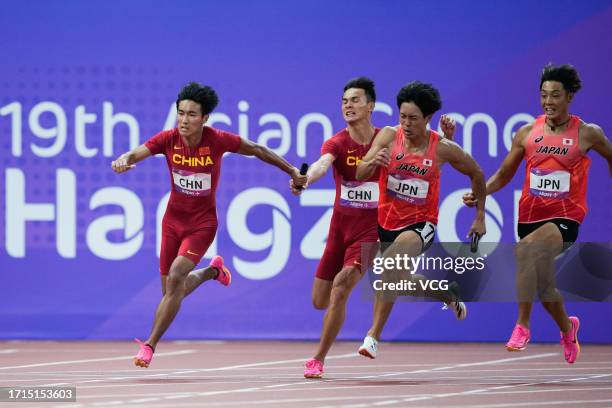 Chen Jiapeng and Yan Haibin of Team China, Uno Shoto and Ueyama Koki of Team Japan compete in the Athletics - Men's 4 x 100m Relay on day ten of the...