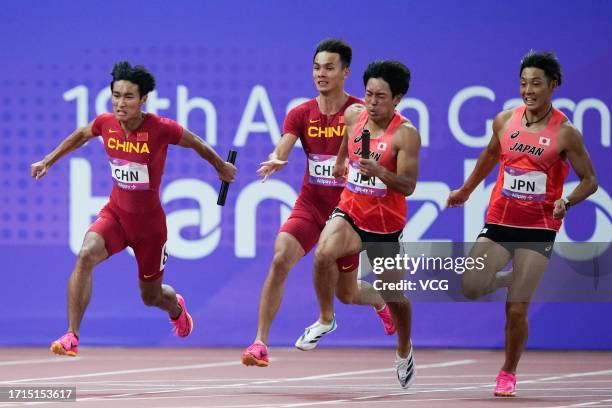 Chen Jiapeng and Yan Haibin of Team China, Uno Shoto and Ueyama Koki of Team Japan compete in the Athletics - Men's 4 x 100m Relay on day ten of the...