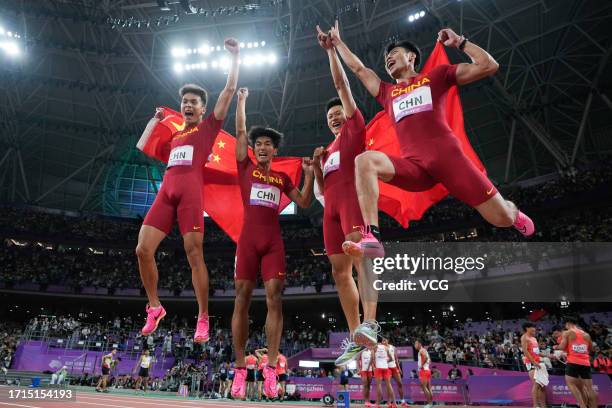 Chen Guanfeng, Xie Zhenye, Yan Haibin and Chen Jiapeng of Team China celebrate after winning the Athletics - Men's 4 x 100m Relay on day ten of the...