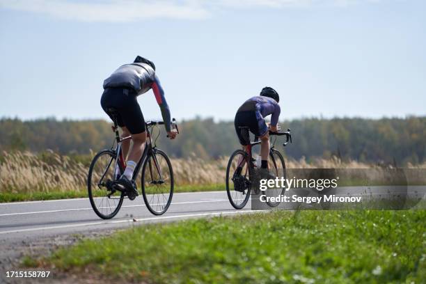 teammates training on road bicycles at countryside - cycling team stock pictures, royalty-free photos & images