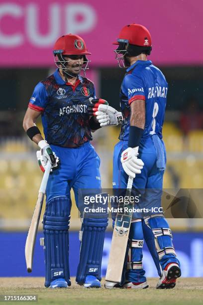Rahmanullah Gurbaz and Rahmat Shah of Afghanistan celebrate between the wickets during the ICC Men's Cricket World Cup India 2023 warm up match...