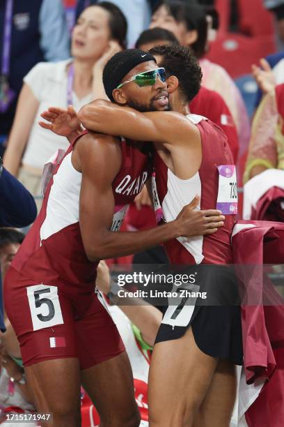 Silver medallist Bassem Hemeida and gold medallist Abderrahman Samba of Qatar celebrate after the end of the men's 400m hurdles final athletics event...