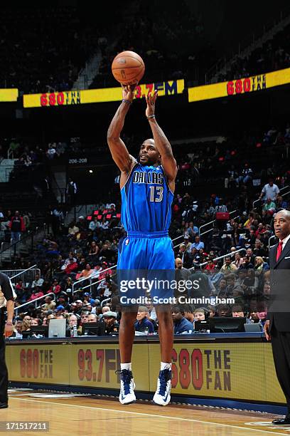 Mike James of the Dallas Mavericks shoots a three pointer against the Atlanta Hawks on March 18, 2013 at Philips Arena in Atlanta, Georgia. NOTE TO...