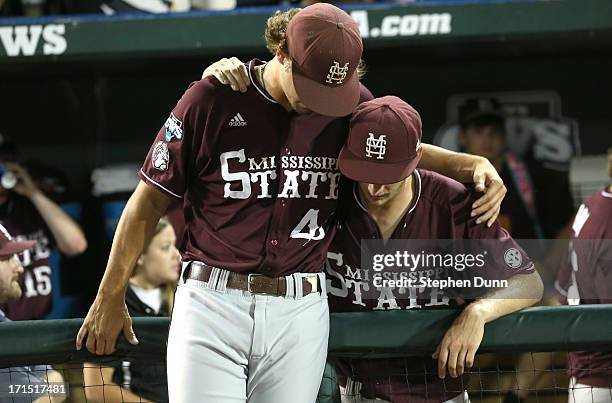 Pitchers Kendall Graveman and Ross Mitchell of the Mississippi State Bulldogs embrace after losing to the UCLA Bruins during game two of the College...
