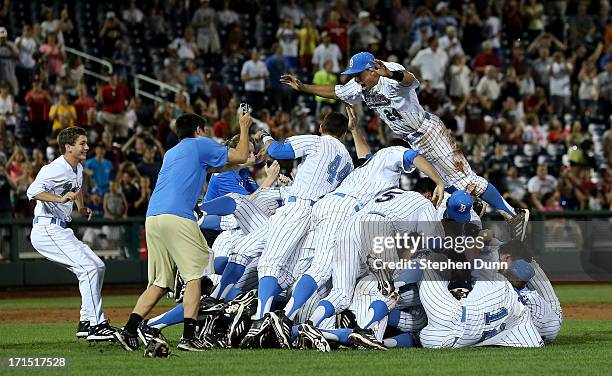 Te UCLA Bruins jump into a pile to celebrate after getting the final out against the Mississippi State Bulldogs during game two of the College World...