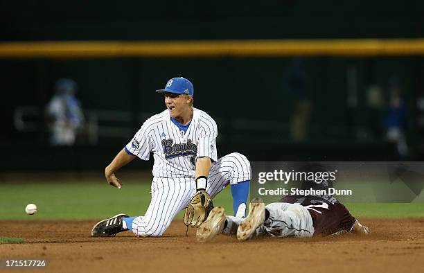 Adam Frazier of the Mississippi State Bulldogs slides into second with a stolen base ahead of the throw to shortstop Pat Valaika of the UCLA Bruins...