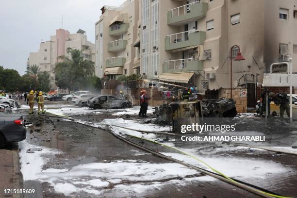 Israeli emergency responders cordon off the site of a rocket attack in the southern Israeli city of Ashdod on October 9, 2023. Israel relentlessly...