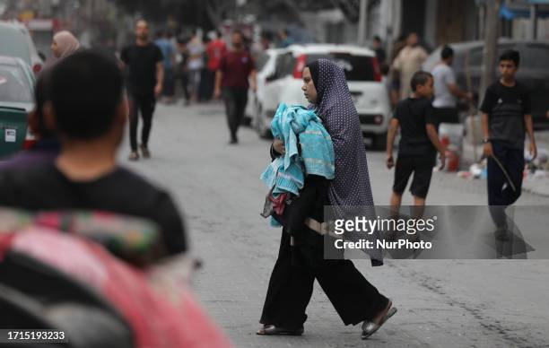 Palestinians evacuate their homes after Israeli strikes on Gaza City on October 9, 2023. The Israeli army said it hit more than 500 targets in the...