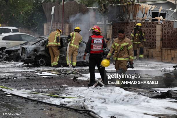 Israeli emergency responders inspect the site of a rocket attack in the southern Israeli city of Ashdod on October 9, 2023. Israel relentlessly...