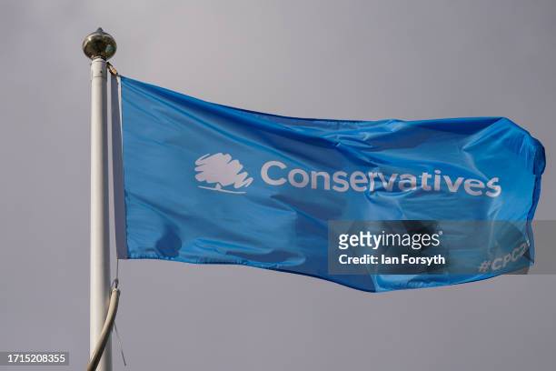 Conservative party flag flies over the conference venue on the third day of the Conservative Party Conference on October 03, 2023 in Manchester,...