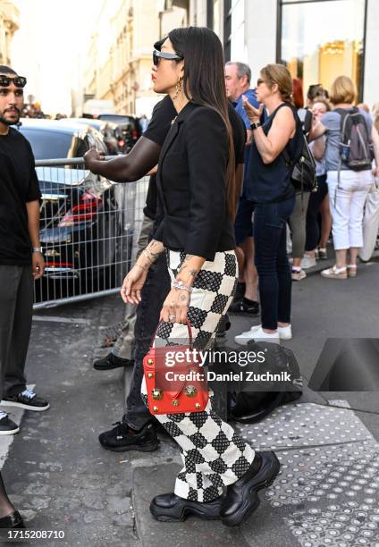 Peggy Gou is seen wearing a black blazer, Louis Vuitton checkered