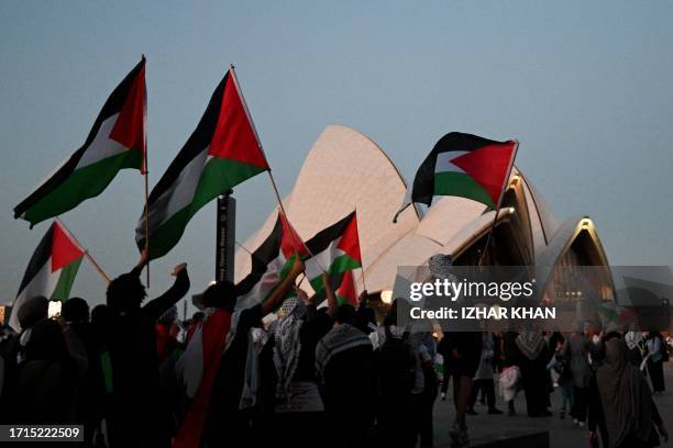 Protesters show their support for Palestinians during a rally in front of the Opera House in Sydney on October 9, 2023. Israel relentlessly pounded...
