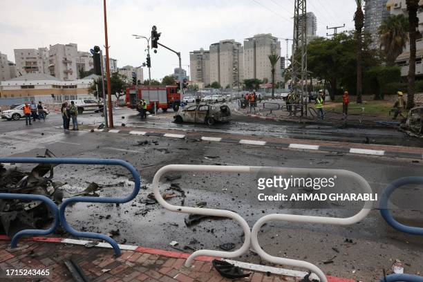 Israeli emergency responders inspect the site of a rocket attack in the southern Israeli city of Ashdod on October 9, 2023. Israel relentlessly...