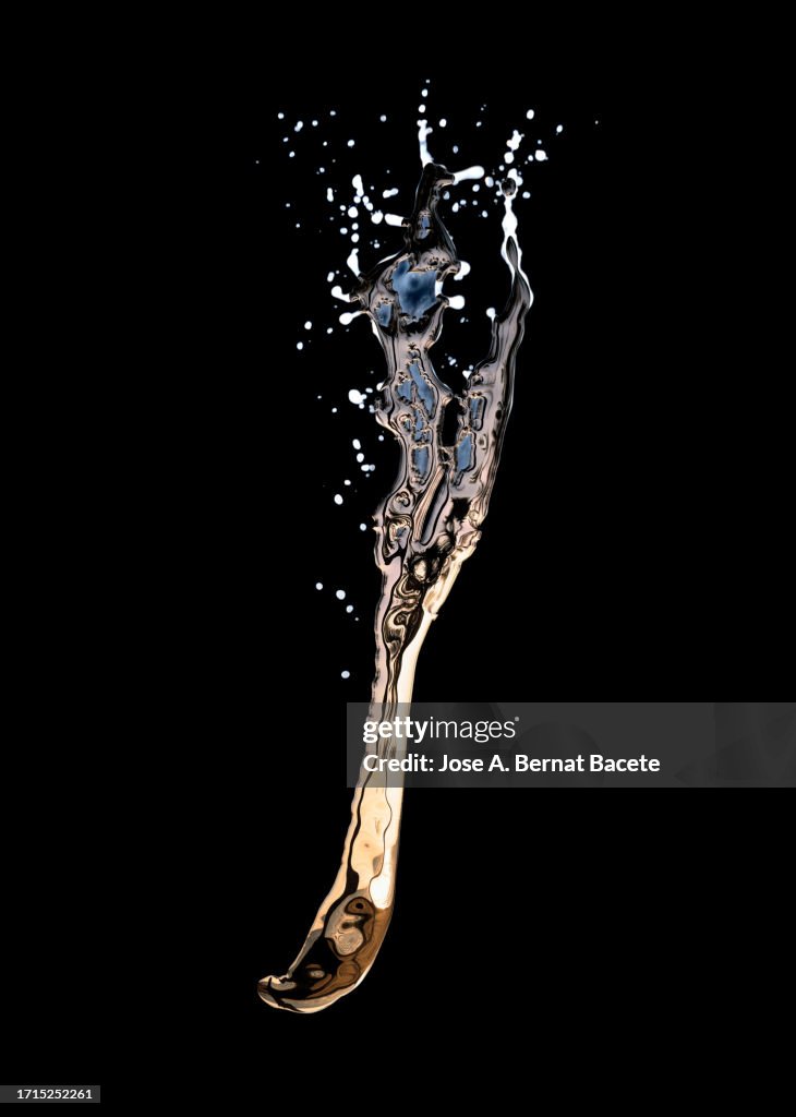 Drops of gold-colored liquid fall on a black background.