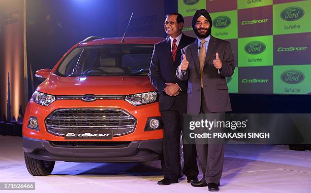 President and Managing Director of Ford India, Joginder Singh , and Vinay Piparsania, Executive Director for Marketing Sales and service, pose with...