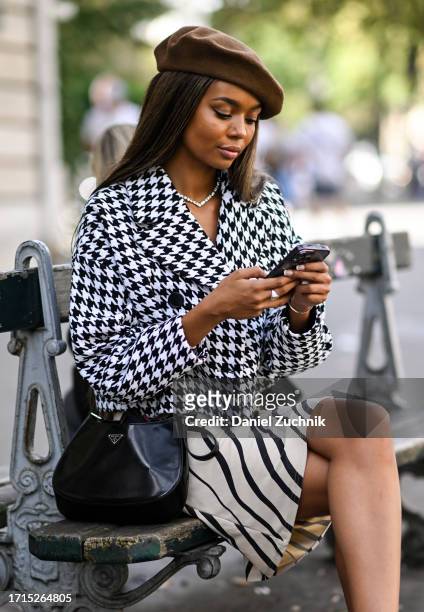 Wendy Thembelihle Juel is seen wearing a black and white chevron jacket, cream and black skirt, black Prada bag and a brown beret outside the...