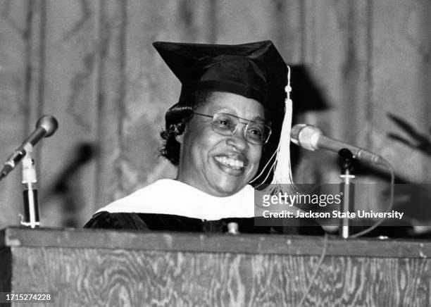 Margaret Walker Alexander, author and educator, dressed in cap and gown, addressing attendees during commencement ceremony.