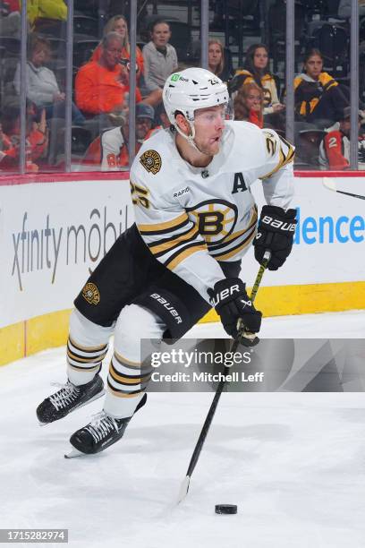 Brandon Carlo of the Boston Bruins controls the puck against the Philadelphia Flyers during the preseason game at the Wells Fargo Center on October...