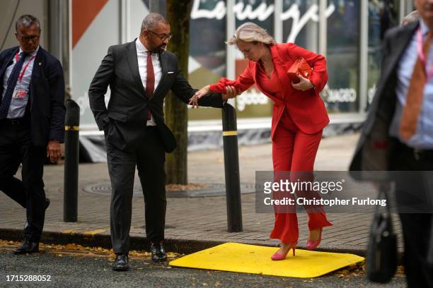 James Cleverly MP, Secretary of State for Foreign, Commonwealth and Development Affairs, assists his wife Susie Cleverly as she walks across an...