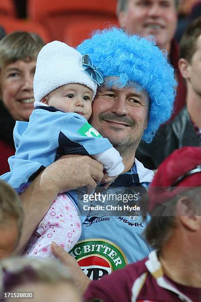 Blues supporter holds his baby before the start of game two of the ARL State of Origin series between the Queensland Maroons and the New South Wales...