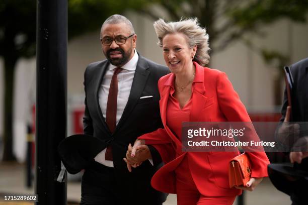 James Cleverly MP, Secretary of State for Foreign, Commonwealth and Development Affairs, and his wife Susie Cleverly walk to the Conservative...