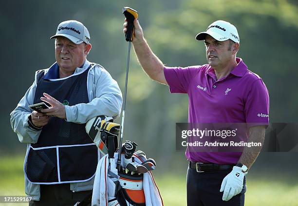 Paul McGinley of Ireland is pictured with his caddie "Edinburgh Jimmy" Rae during the pro-am event prior to the start of the Irish Open at Carton...