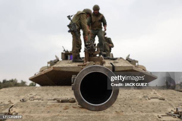 Israeli army soldiers are positioned with their Merkava tanks near the border with the Gaza Strip in southern Israel on October 9, 2023. Israel...