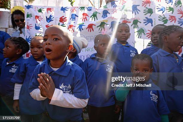 Children gather to leave messages of support for former South African President Nelson Mandela outside the Mediclinic Heart Hospital June 26, 2013 in...