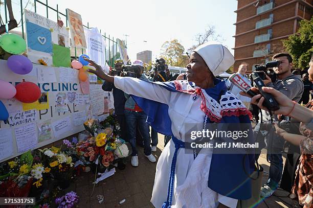 People gather to leave messages of support for former South African President Nelson Mandela outside the Mediclinic Heart Hospital June 26, 2013 in...