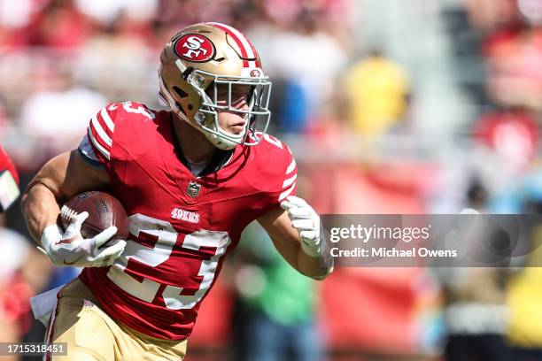 Christian McCaffrey of the San Francisco 49ers runs with the ball during an NFL football game between the San Francisco 49ers and the Arizona...