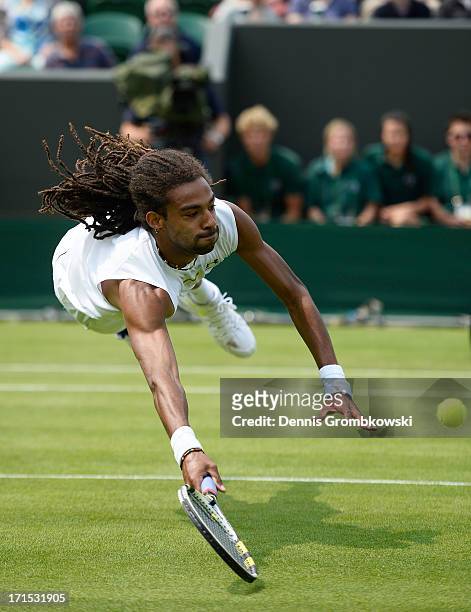 Dustin Brown of Germany dives to return a shot during his Gentlemen's Singles second round match against Lleyton Hewitt of Australia on day three of...