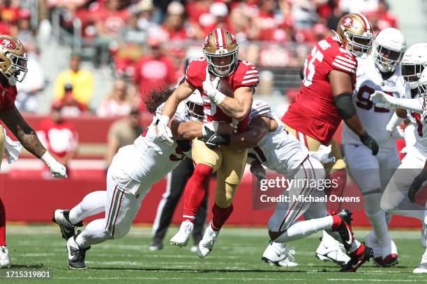 Christian McCaffrey of the San Francisco 49ers runs with the ball during an NFL football game between the San Francisco 49ers and the Arizona...