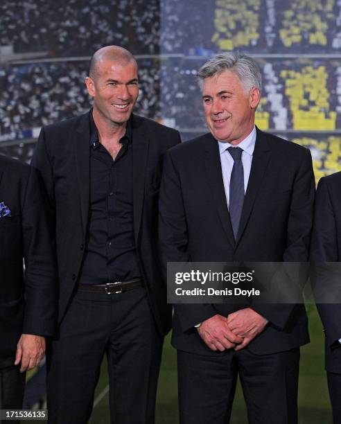 Carlo Ancelotti smiles as he stands alongside former player Zinedine Zidane during his presentation as the new head coach of Real Madrid at Estadio...