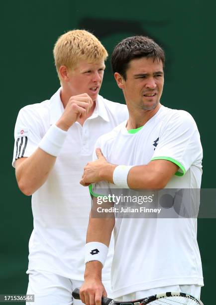 Kyle Edmund and Jamie Baker of Great Britain look on during their Gentlemen's Doubles first round match against David Marrero of Spain and Andreas...