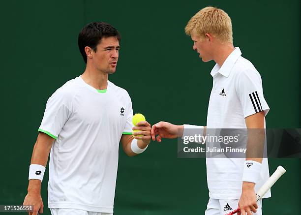 Kyle Edmund and Jamie Baker of Great Britain tap hands during their Gentlemen's Doubles first round match against David Marrero of Spain and Andreas...