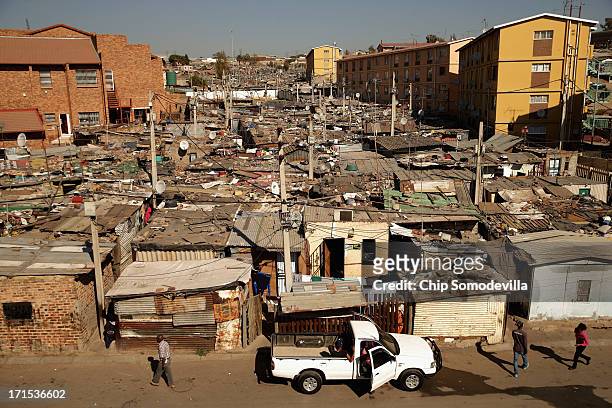 Built in a haphazard swath, shacks stretch on to the horizon in Alexandra Township June 26, 2013 in Johannesburg, South Africa. A township with a...