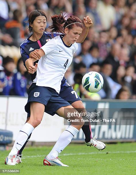 Jill Scott of England shields the ball from Kozue Ando of Japan during the friendly match between England Women and Japan at Pirelli Stadium on June...