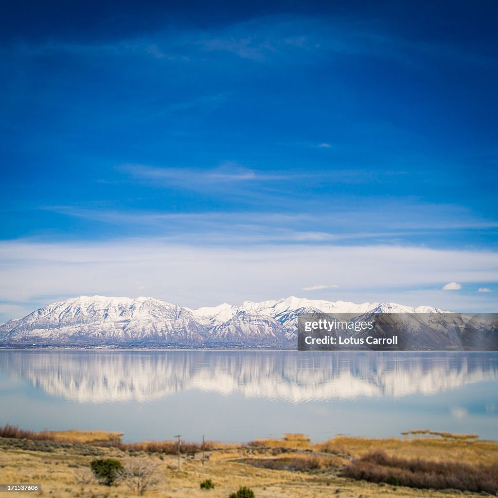 Mountain Range reflected in blue water