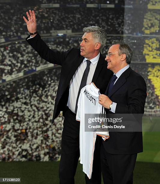 Carlo Ancelotti holds up a Real Madrid shirt with Real president Florentino Perez while being presented as Real's new head coach at Estadio Bernabeu...