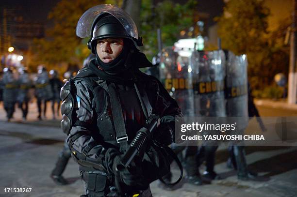 Member of the anti riot police Tropa de Choque is seen during a protest in Niteroi, outside Rio de JAneirp on June 25, 2013. Brazil is currently...