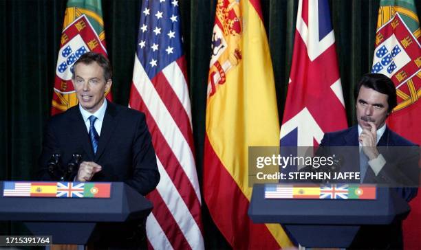 Spanish Prime Minister Jose Maria Aznar listen to Britain's Prime Minister Tony Blair during a joint press conference following meetings to discuss...