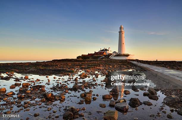 a lighthouse for dangerous coastline. - tyne and wear stock pictures, royalty-free photos & images