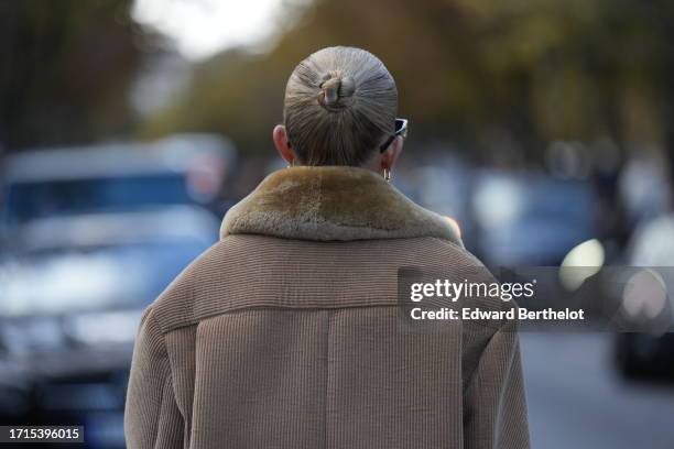 Guest wears a brown corduroy jacket, outside Miu Miu, during the Womenswear Spring/Summer 2024 as part of Paris Fashion Week on October 03, 2023 in...