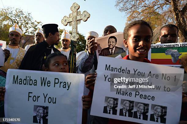 People gather to leave messages of support for former South African President Nelson Mandela outside the Mediclinic Heart Hospital June 26, 2013 in...