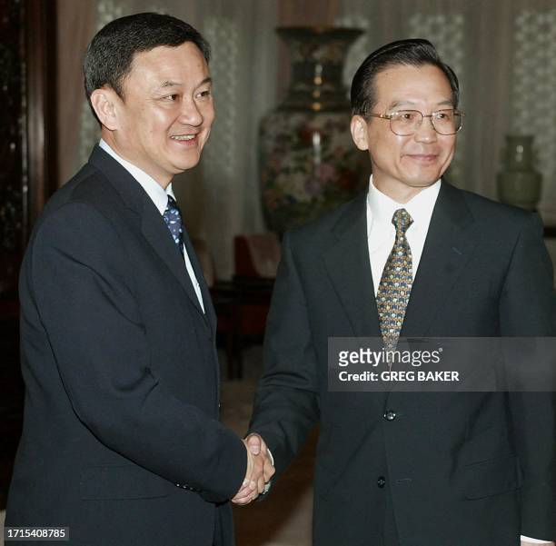 Thai Prime Minister Thaksin Shinawatra , is greeted by Chinese Vice Premier Wen Jiabao at the Zhongnanhai leadership compound in Beijing, 19 February...