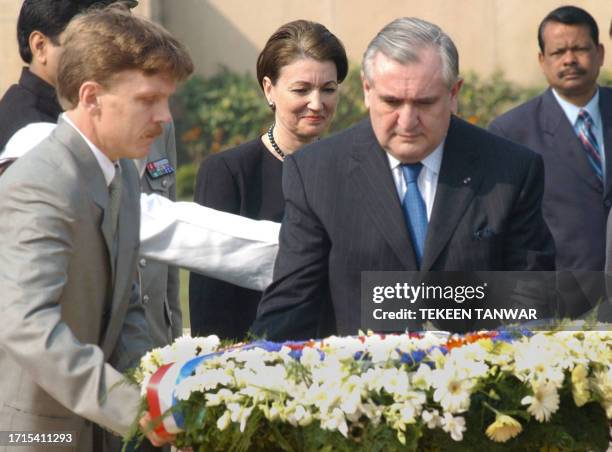 Anne-Marie Raffarin watches her husband French Prime Minister Jean-Pierre Raffarin place a wreath on the monument to Mahatma Gandhi 07 February 2003...